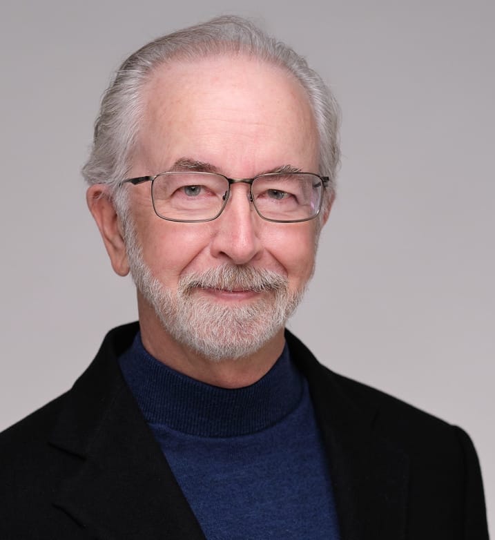 Dr. Brent Fultz, older gentleman with glasses wearing a black blazer and dark blue shirt
